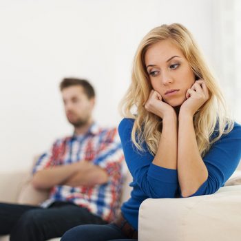 Couple on couch not getting along