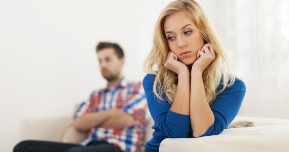 Couple on couch not getting along