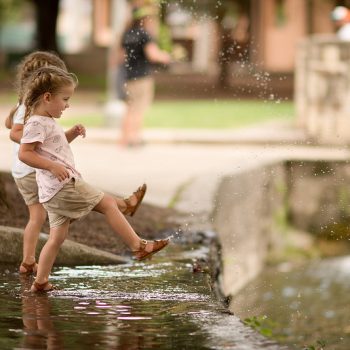 Children playing near water outside