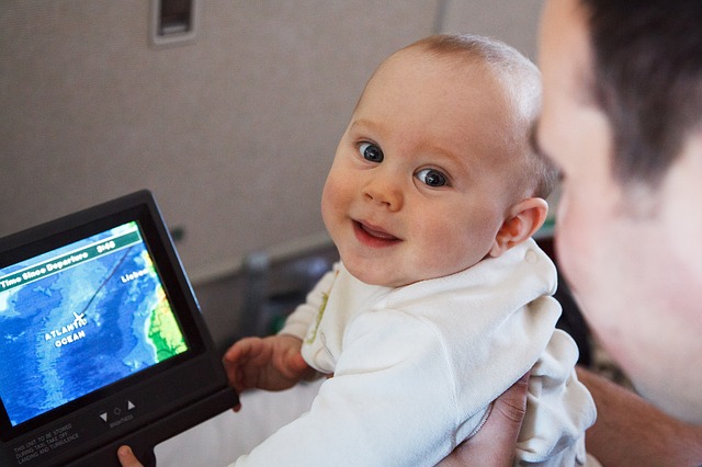 Baby in front of a digital travel screen