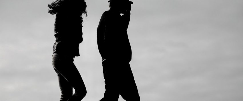 Silhouettes of couple walking