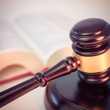 Gavel resting next to book