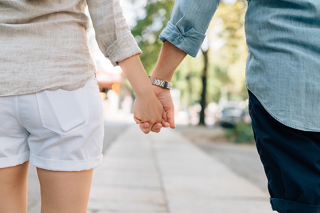 Man and woman holding hands outside