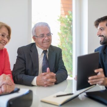 elderly couple at table with lawyer