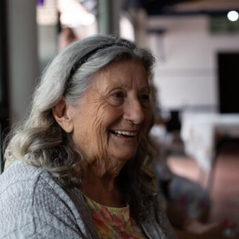 smiling woman with gray hair in a nursing home