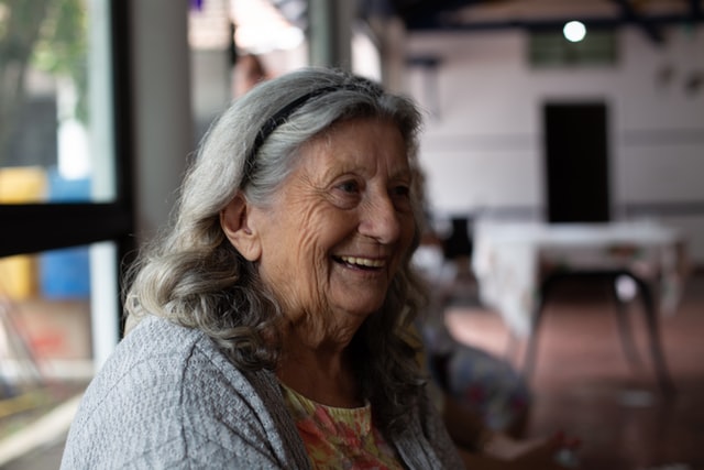 smiling woman with gray hair in a nursing home