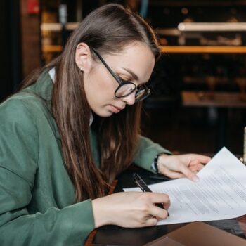 woman signing papers