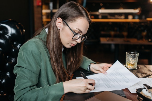 woman signing papers