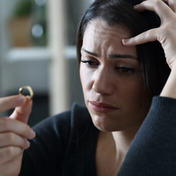 woman contemplating a wedding ring