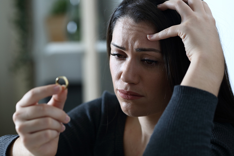 woman contemplating a wedding ring