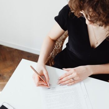 woman signing papers