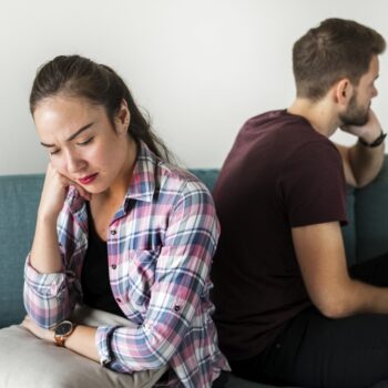 man and woman upset back to back